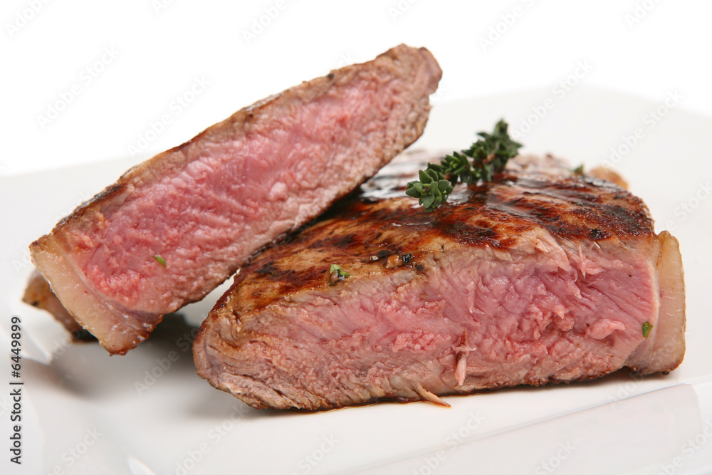 Rare sirloin steak garnished with thyme