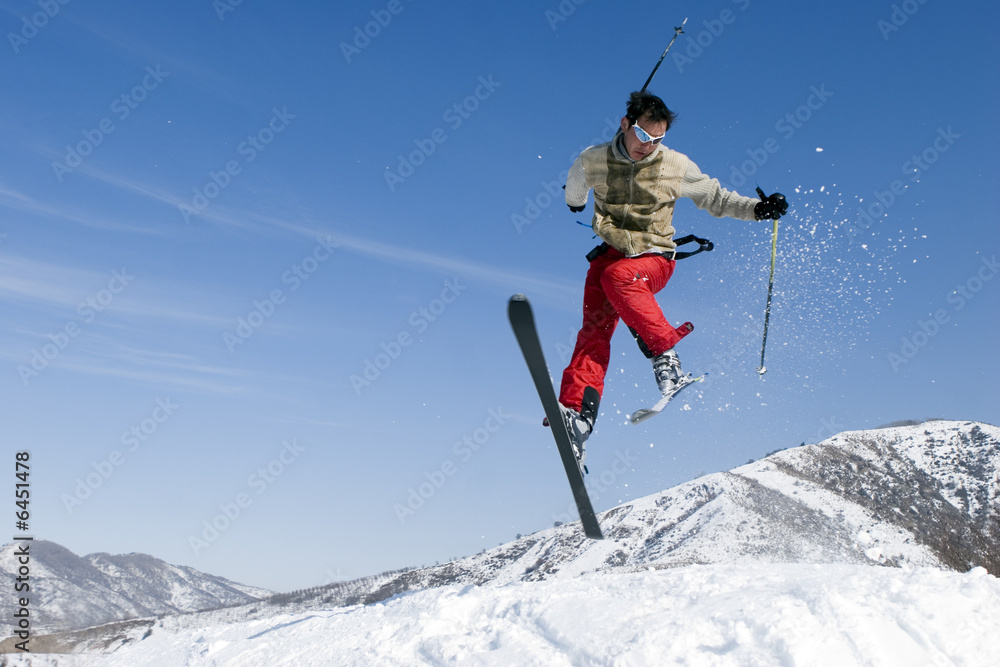 Snow Skier Jumping Against Blue Sky Snow Skier Jumping Against Blue Sky
