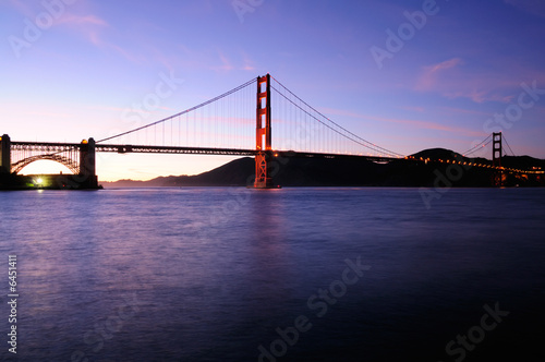 South tower of Golden Gate Bridge glows and beautiful sunset sky