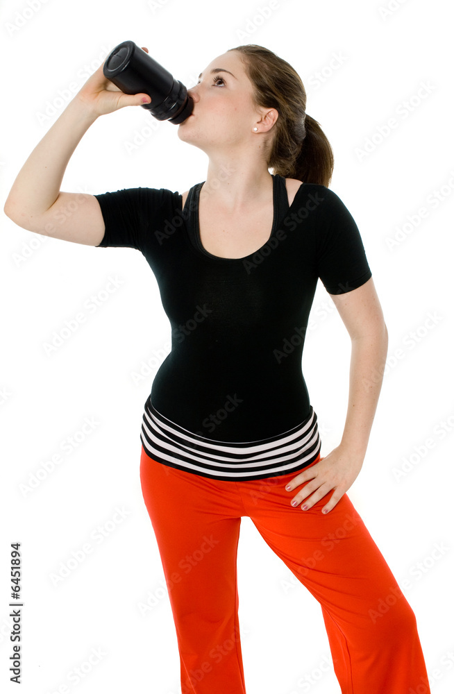 Young caucasian girl drinking from an exercise bottle Young caucasian girl drinking from an exercise bottle