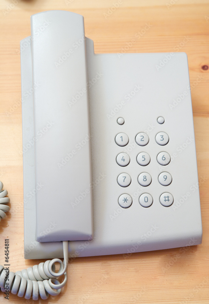White telephone on the table of wood White telephone on the table of wood