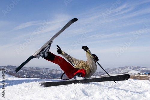 Snow Skier Jumping Against Blue Sky