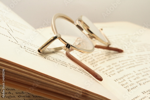 Pice of book and brown glasses