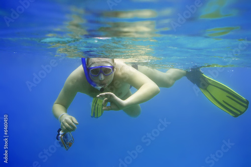 Snorkeling with camera. Photographer.