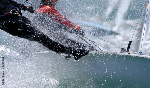 Sailors splash through the waves during a regatta.