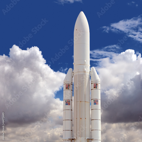 Spaceship against the cloudy sky background