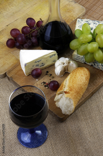 Romantic dinner with wine and cheese on rustic board