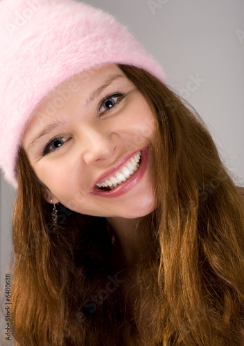 close-up portrait of young woman in pink cap