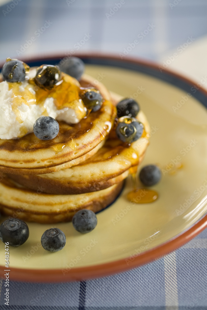 Delicious pancakes with ricotta, blueberries and honey