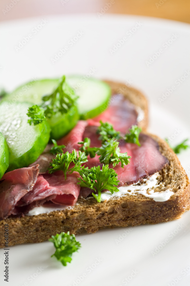 Delicious healthy sandwich on brown with roastbeef and cucumber Delicious healthy sandwich on brown with roastbeef and cucumber