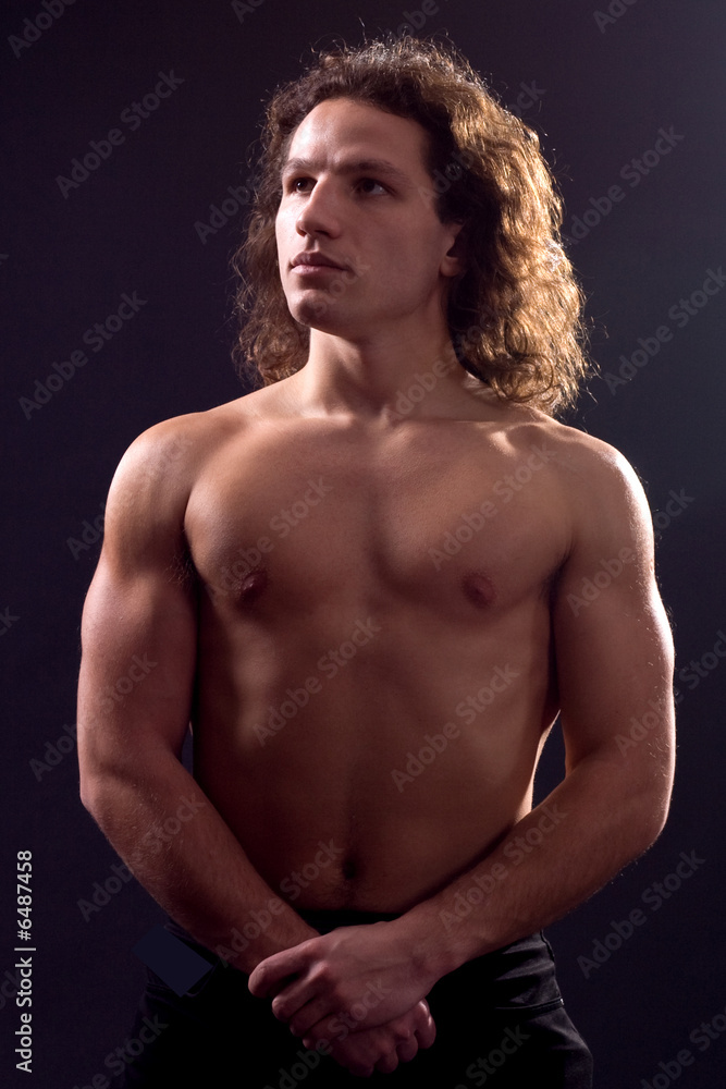 Portrait of athlete on black.