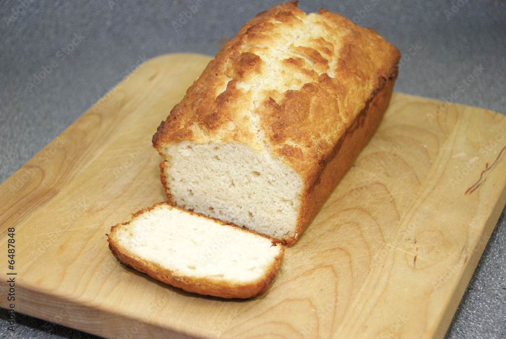 A slice of golden brown homemade bread on a cutting board