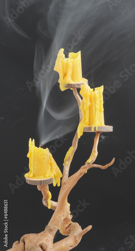 Three candles on a wooden candlestick