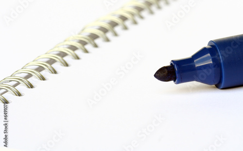 blue marker on white notebook