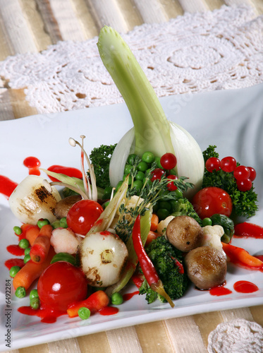 Fried vegetable salad detail on white plate photo