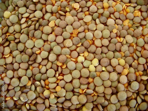 Close up image of green and orange lentils mixed together