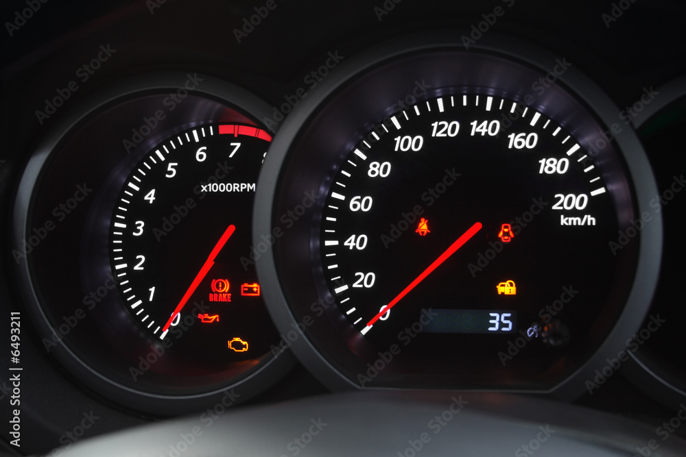 Closeup shot of a speedometer and tachometer of a modern car.