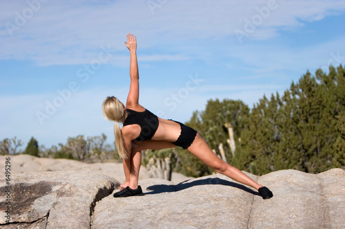 Young woman doing yoga outdoors