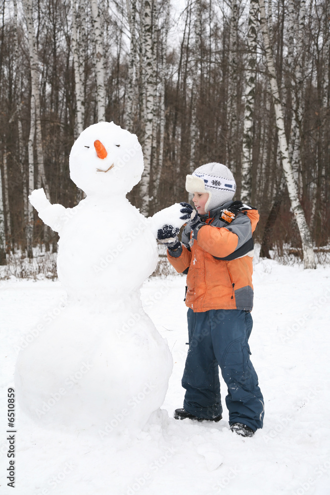 boy makes snowman