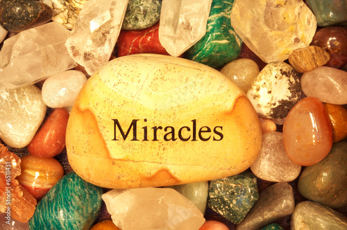 Stones and Crystals with a rock the says miracles on it