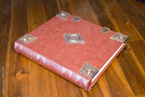 Embossed Leather Bound Book (Spine On) resting on a timber table