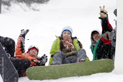 Group of sports teenagers snowborders in mountains in snow
