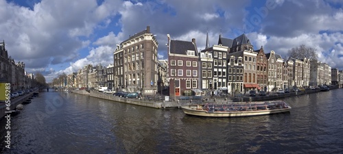 Amsterdam innercity with cruiseboat in canal in the Netherlands photo