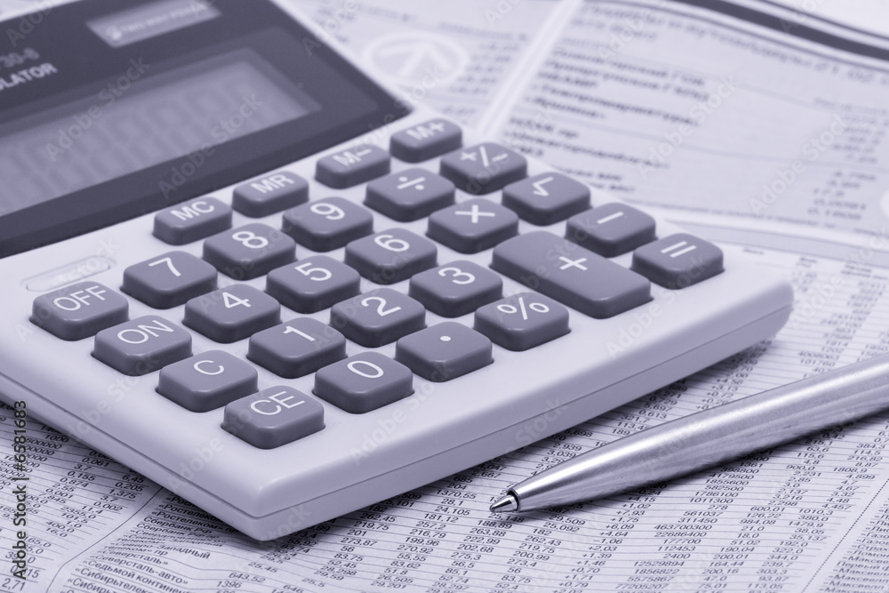 economic newspaper with pen and calculator