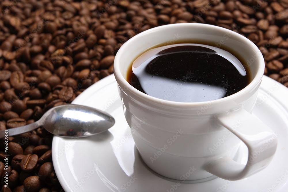 Obraz premium Cup with coffee, costing on coffee grain