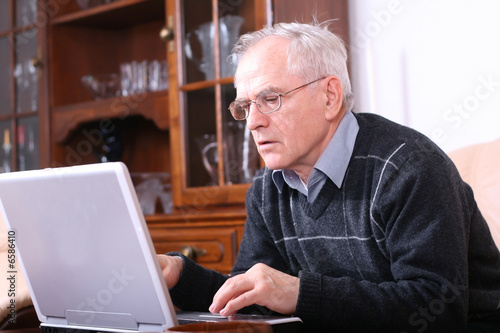 Senior man in front of his laptop