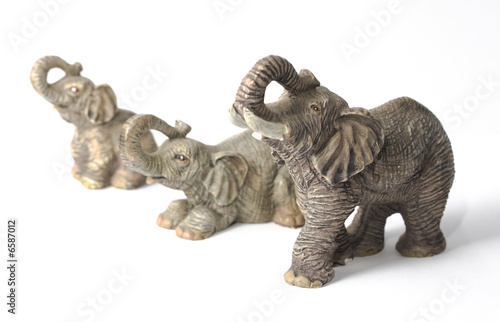 Three elephant figurines, isolated on white background © Daniel Loncarevic