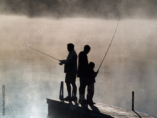 Early morning fishing in autumn on a lake.