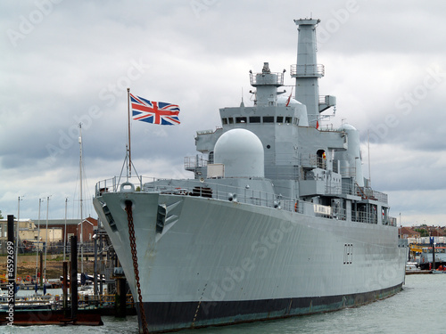 British war ship tied alongside.