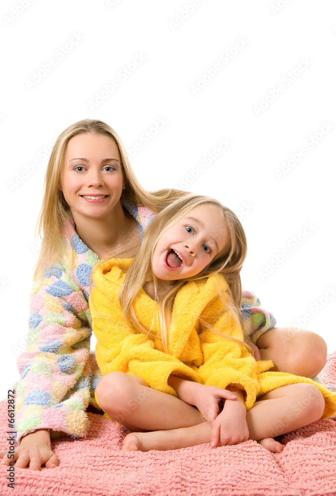 Mother and her daughter sitting on a bed