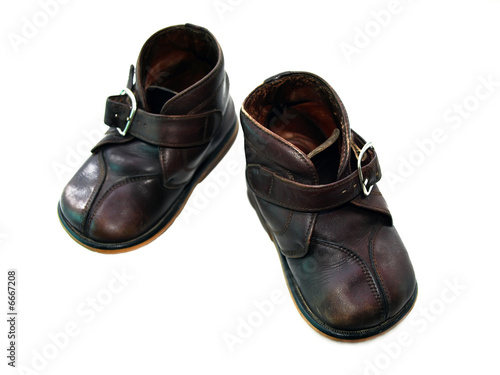Child's old boots isolated over a white background 