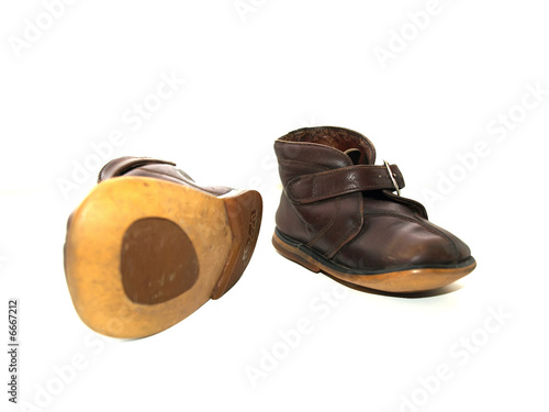 Child's old boots isolated over a white background