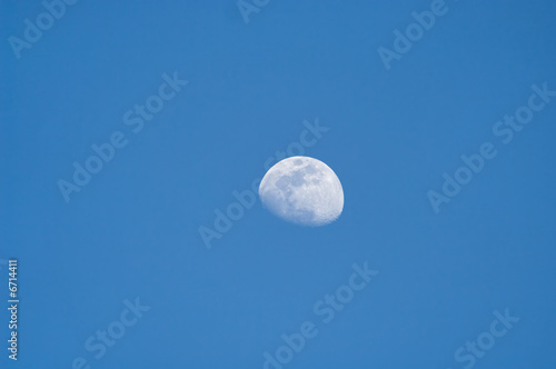 Three quarter moon in blue sky