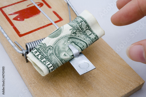 Money Trap - US Dollar being taken from a rat trap