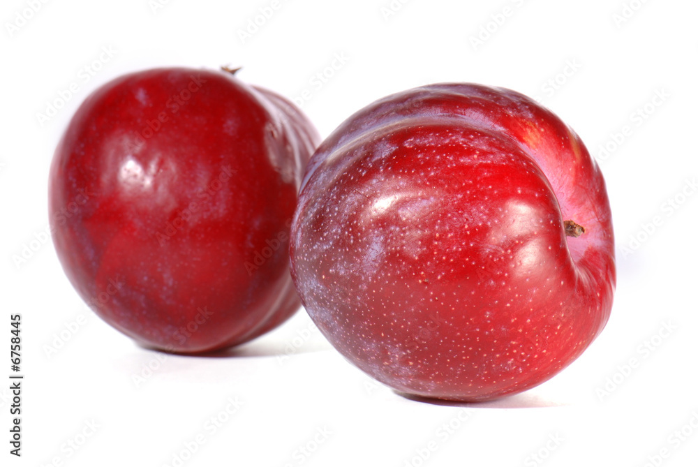 Red plums isolated on white background