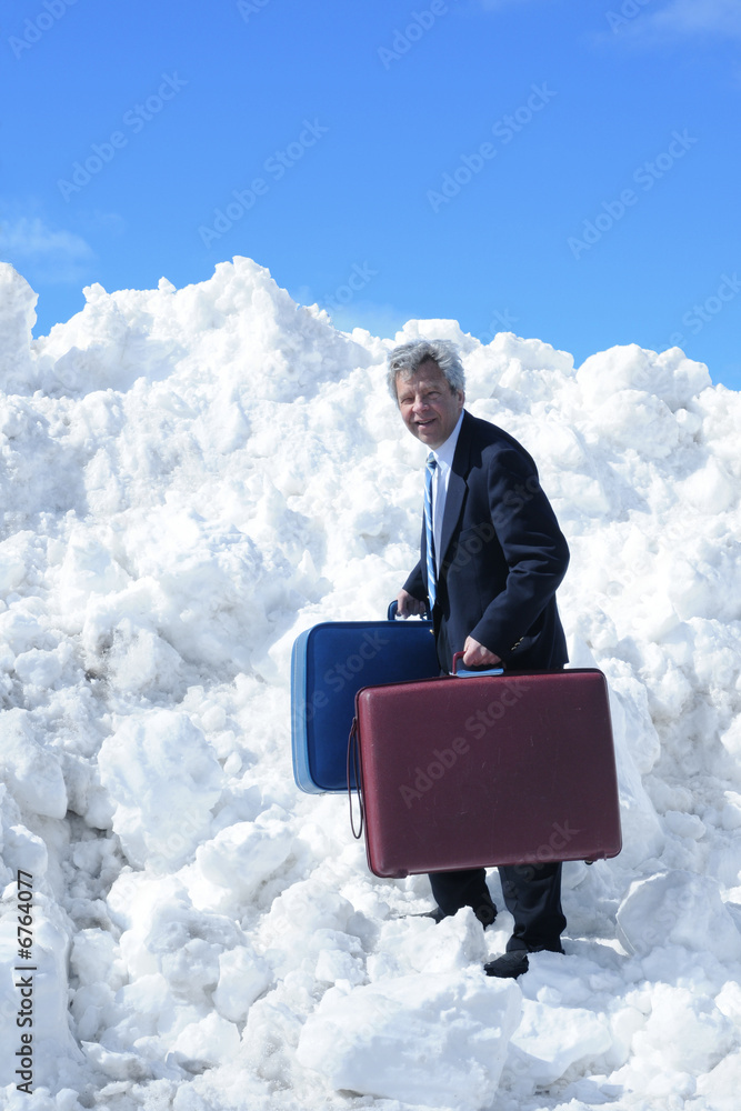 Traveling businessman climbing a snow hill Traveling businessman climbing a snow hill