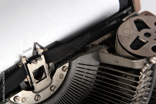typewriter typing news, angle view