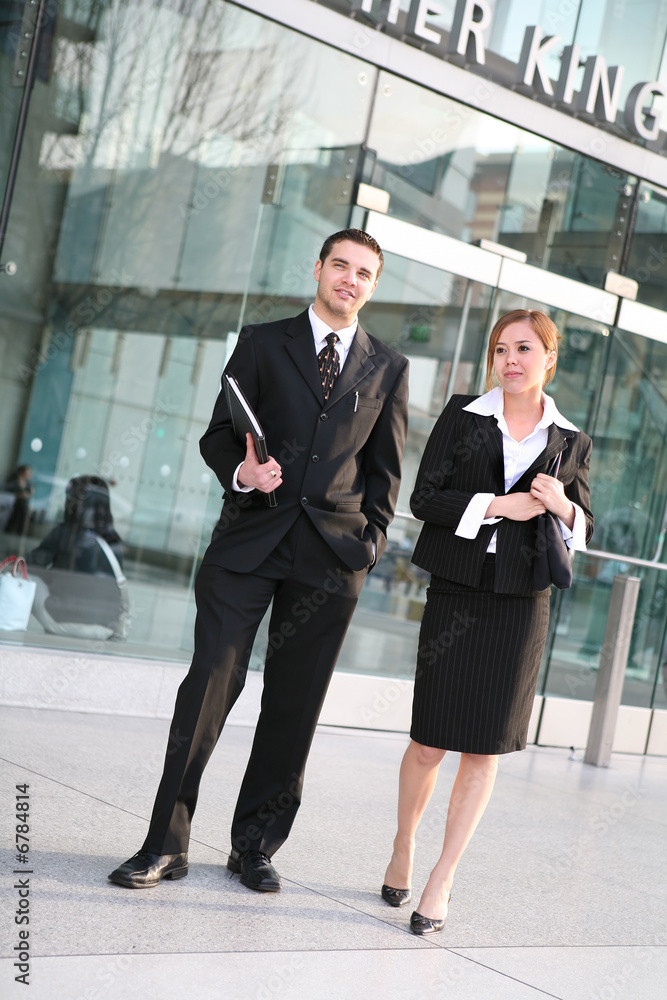 An attractive business team in front of company An attractive business team in front of company