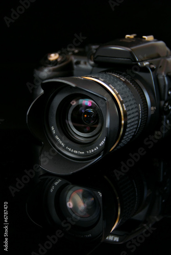 modern profesionalny camera SLR on the black background