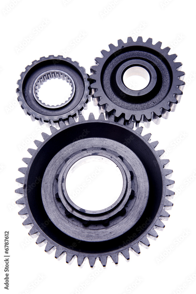 Three gears meshing together over white Three gears meshing together over white
