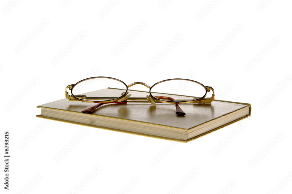 hardcover book and glasses on White Background