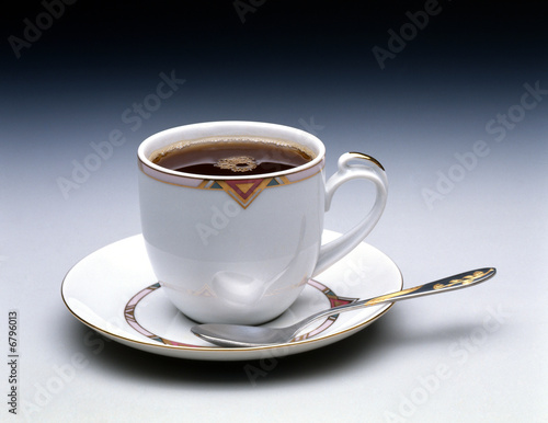 Cup of hot black tea on black background. 