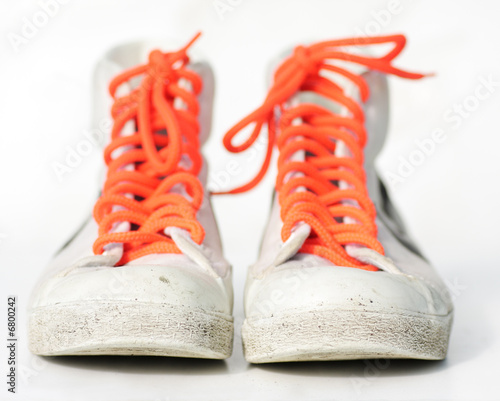 old retro sneakers with orange laces