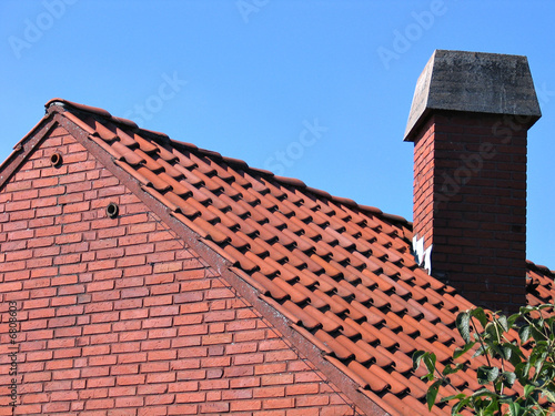 Roof with red tiles and a chimney