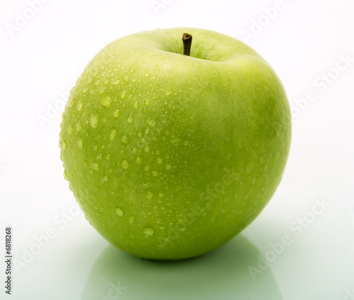 A green apple with water drops