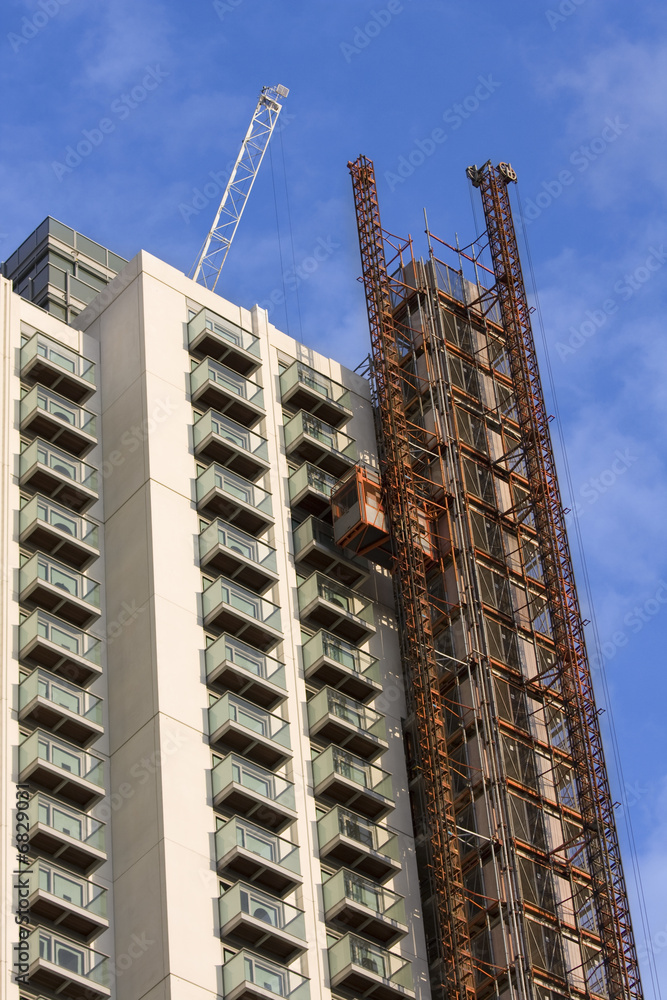 Fototapeta premium Construction site with crane and unfinished building